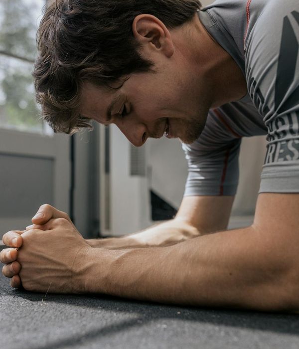 A man holding a challenging balance pose, showing focus and stability.